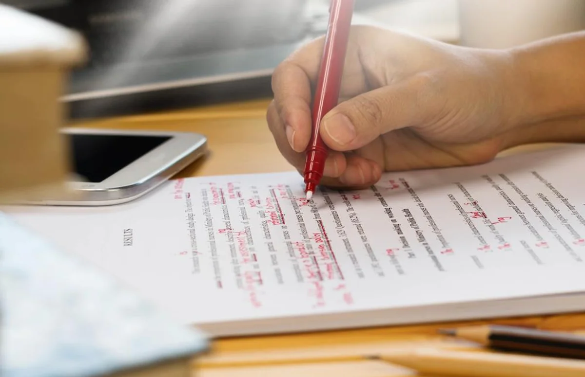 marked cv with red pen recruiter error correction