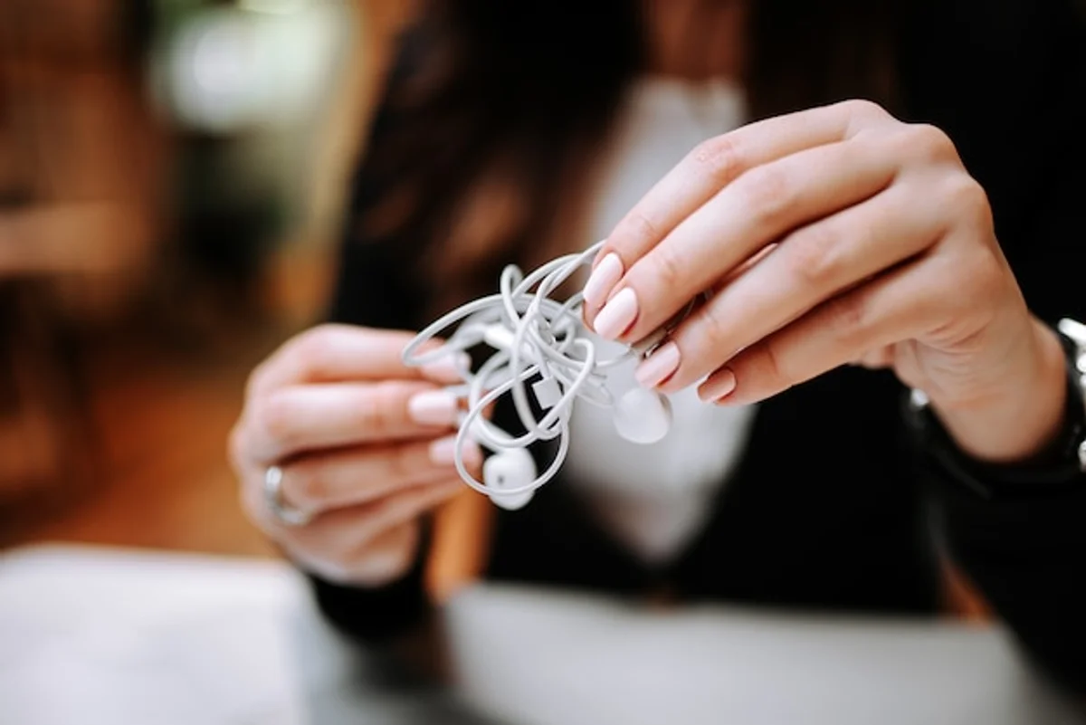 tangled headphone cable in hand close up