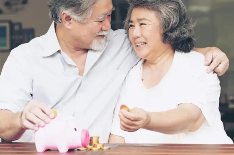 happy seniors saving money together at home
