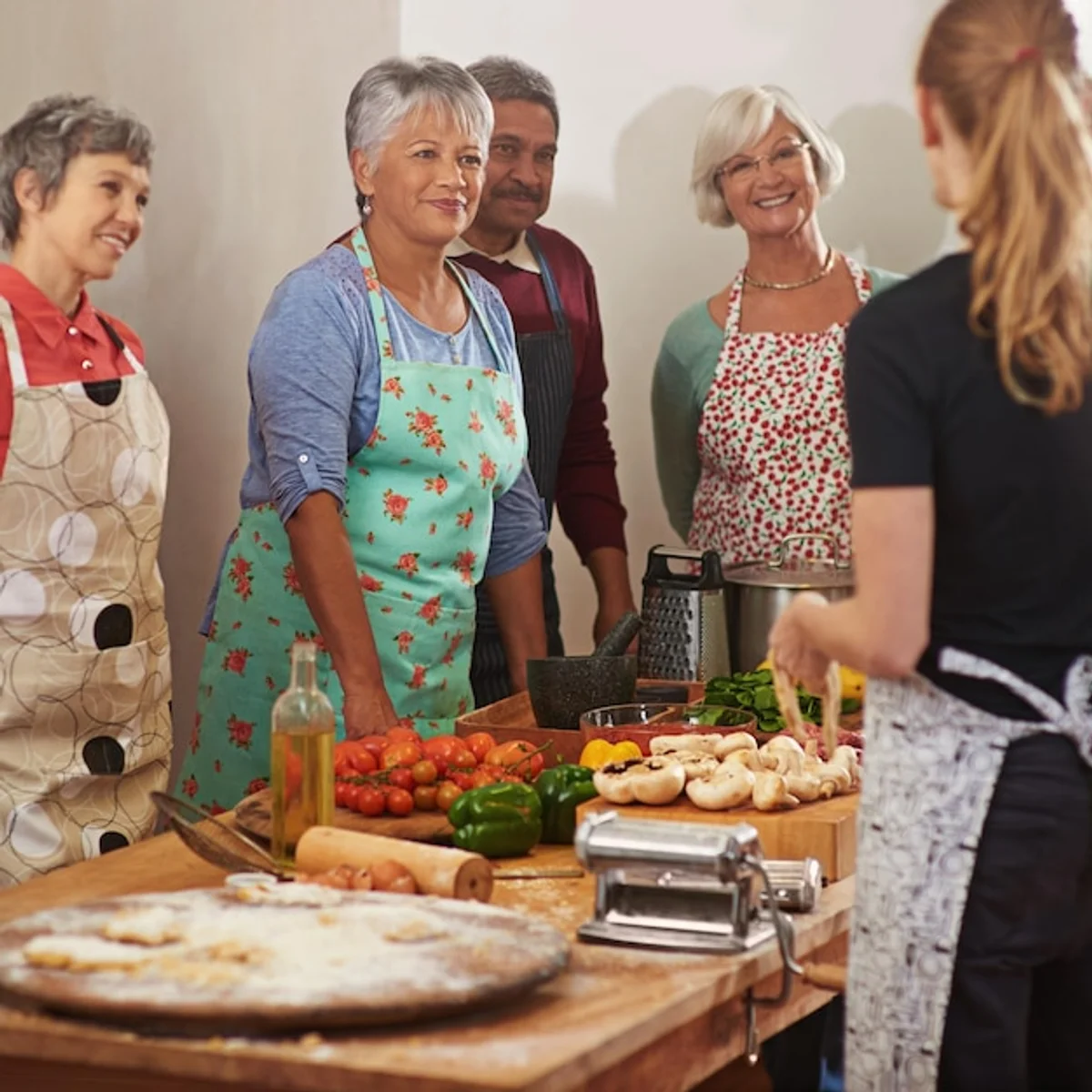 senior friends cooking together in a bright kitchen
