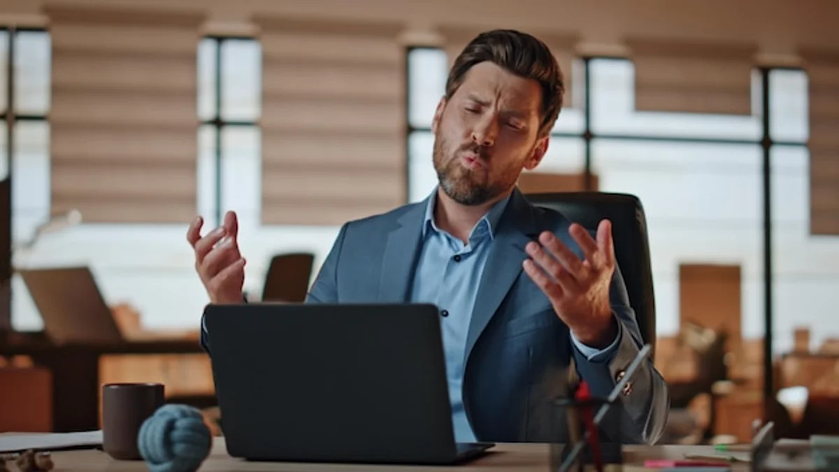 german office worker stressed at desk closeup