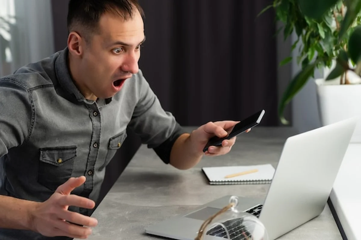 frustrated person lost data smartphone laptop