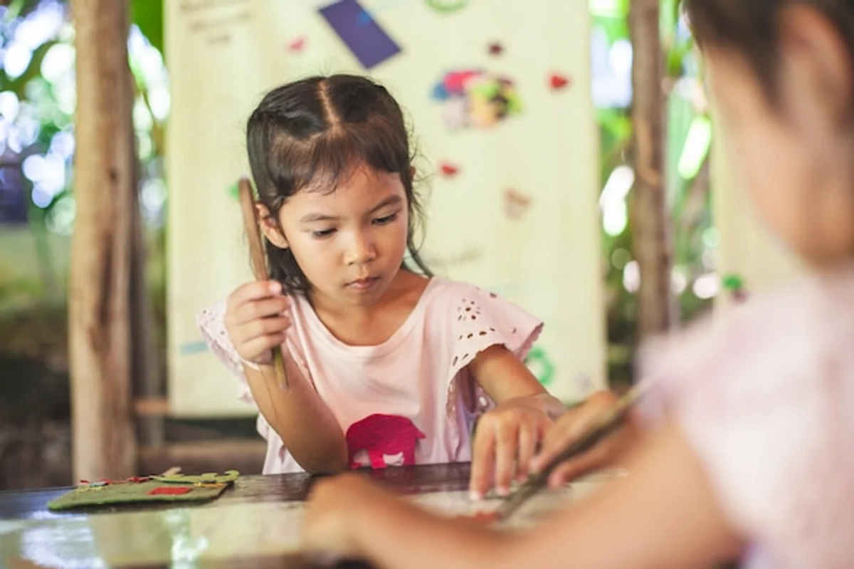 Children crafting with recycled newspaper at home