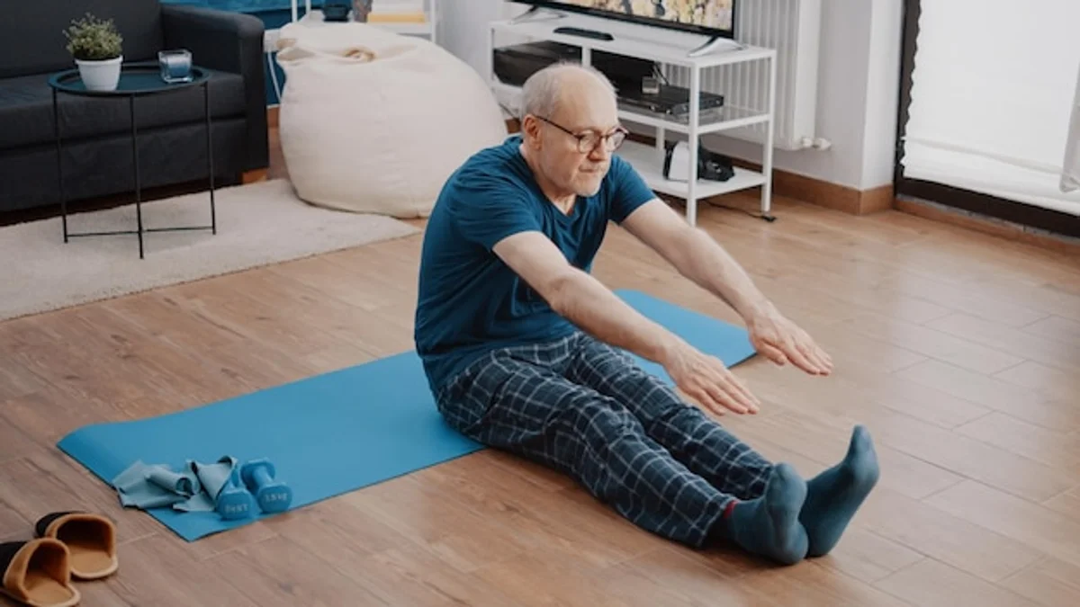 senior man yoga living room germany