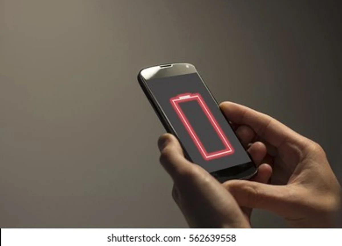 holding smartphone battery low notification real hands german desk