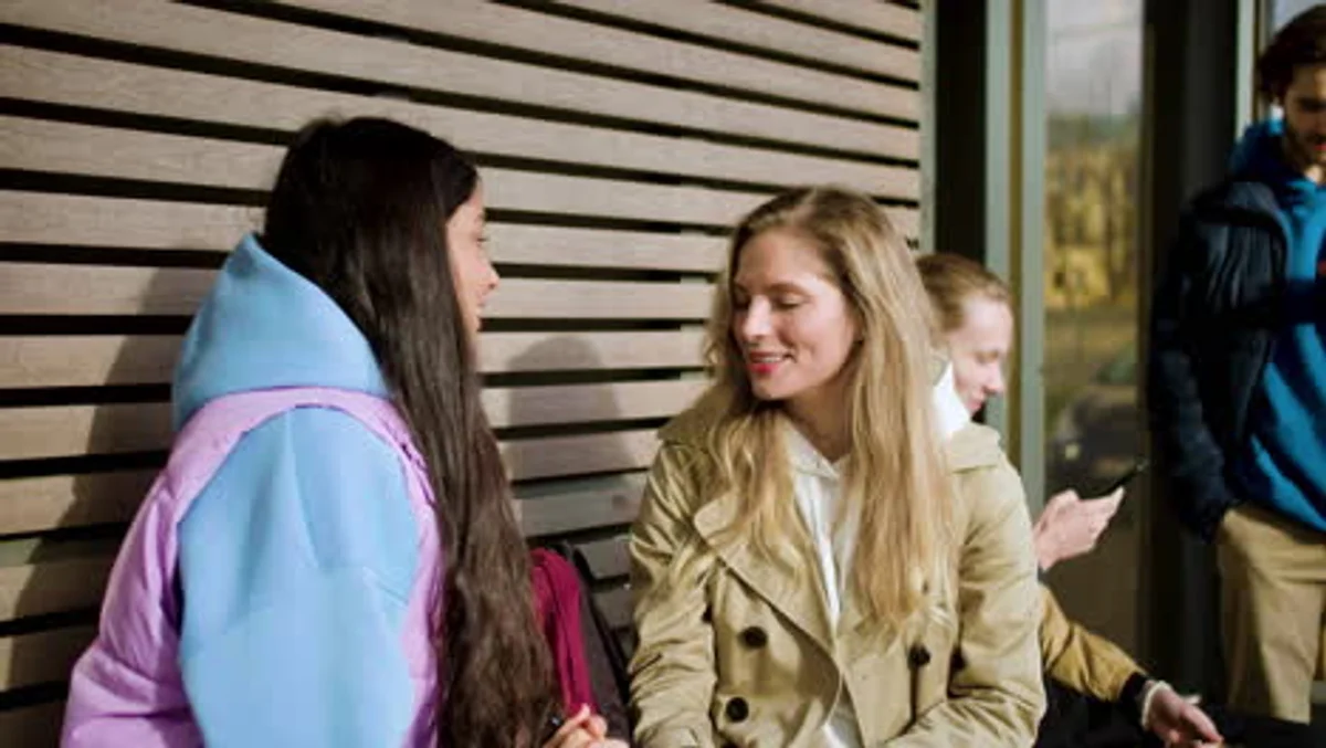 close up of two people talking, one actively listening, warm atmosphere