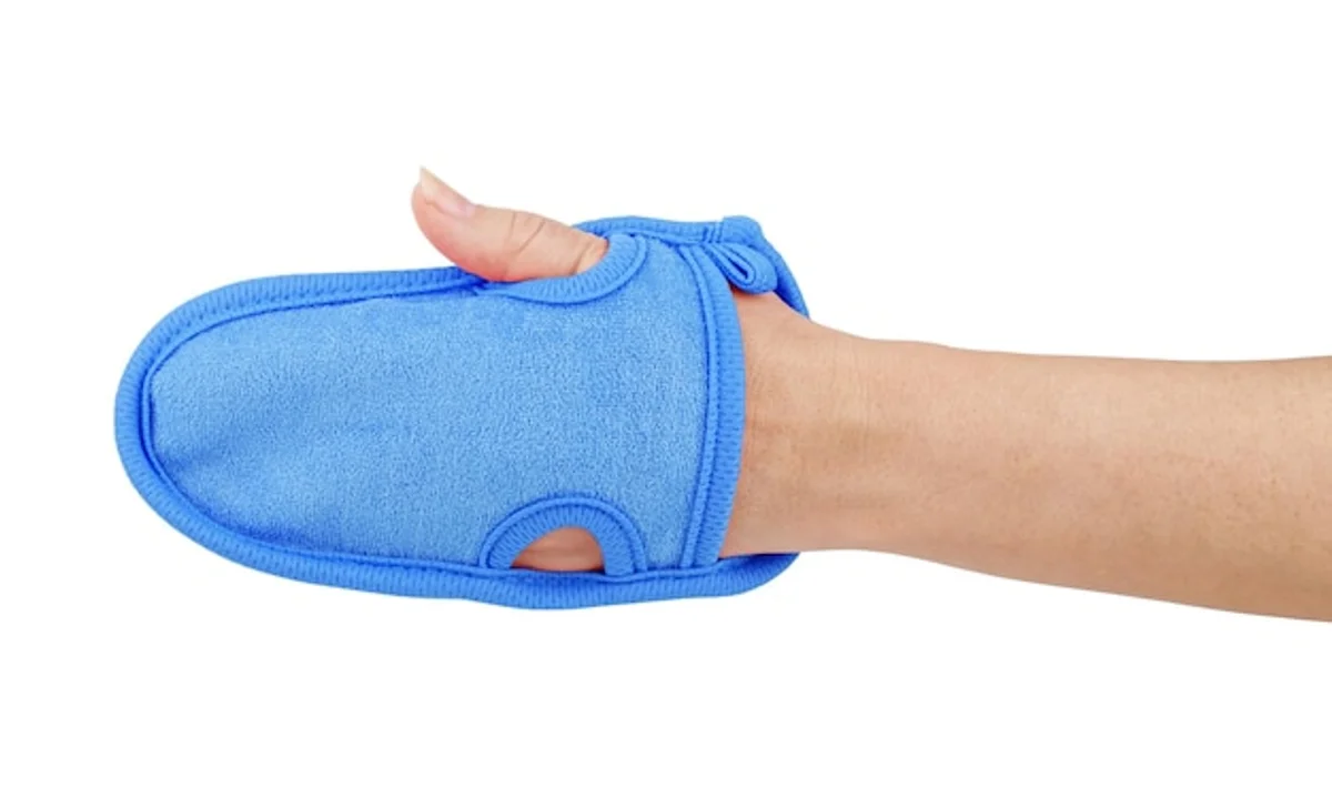 hand holding sock as sponge in kitchen cleaning