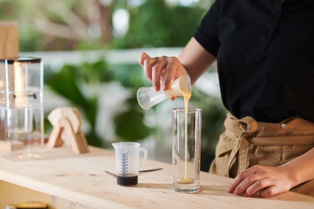 barista checking water temperature for coffee brewing