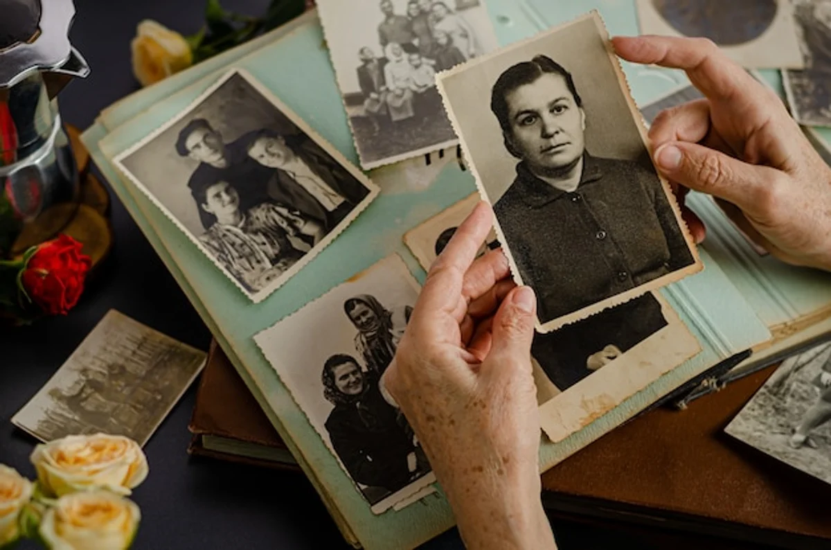 old family photo album on wooden table nostalgic hands