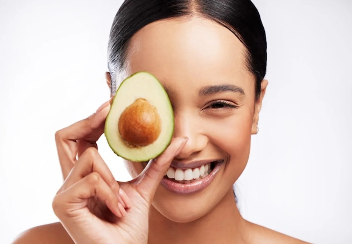 woman applying olive oil to face home care natural glow