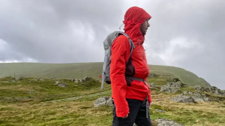 hiker wearing waterproof jacket in heavy rain adventure germany