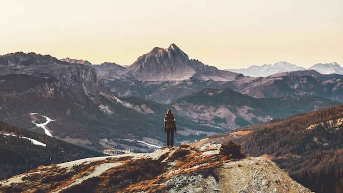 hiker in the Alps with rain jacket in heavy mountain rain