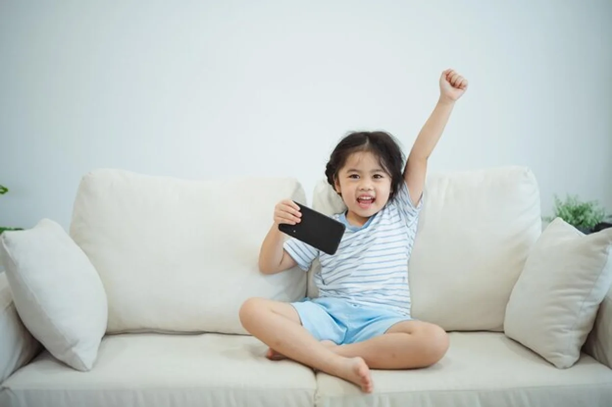 children excessive screen time smartphone sofa living room