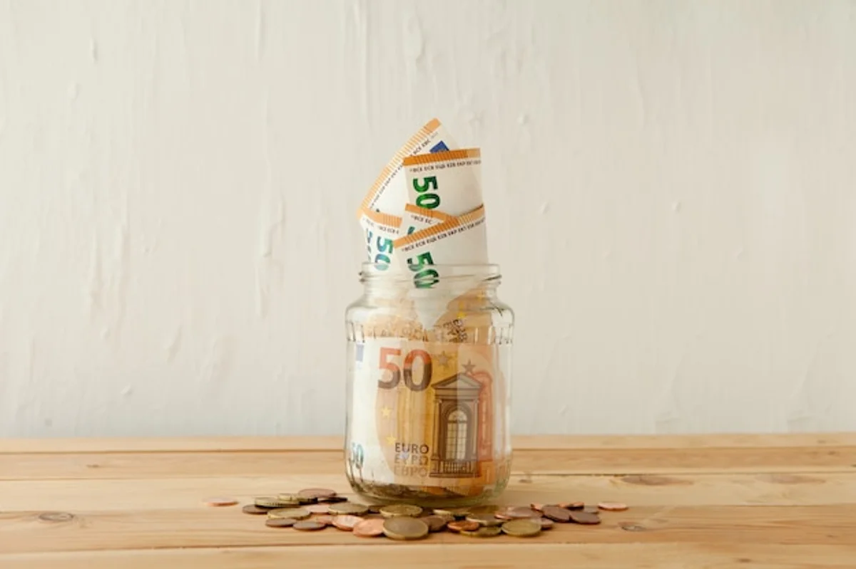 saving money jar euros at home table