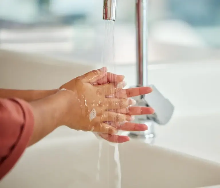 woman washing face hot water bad skincare