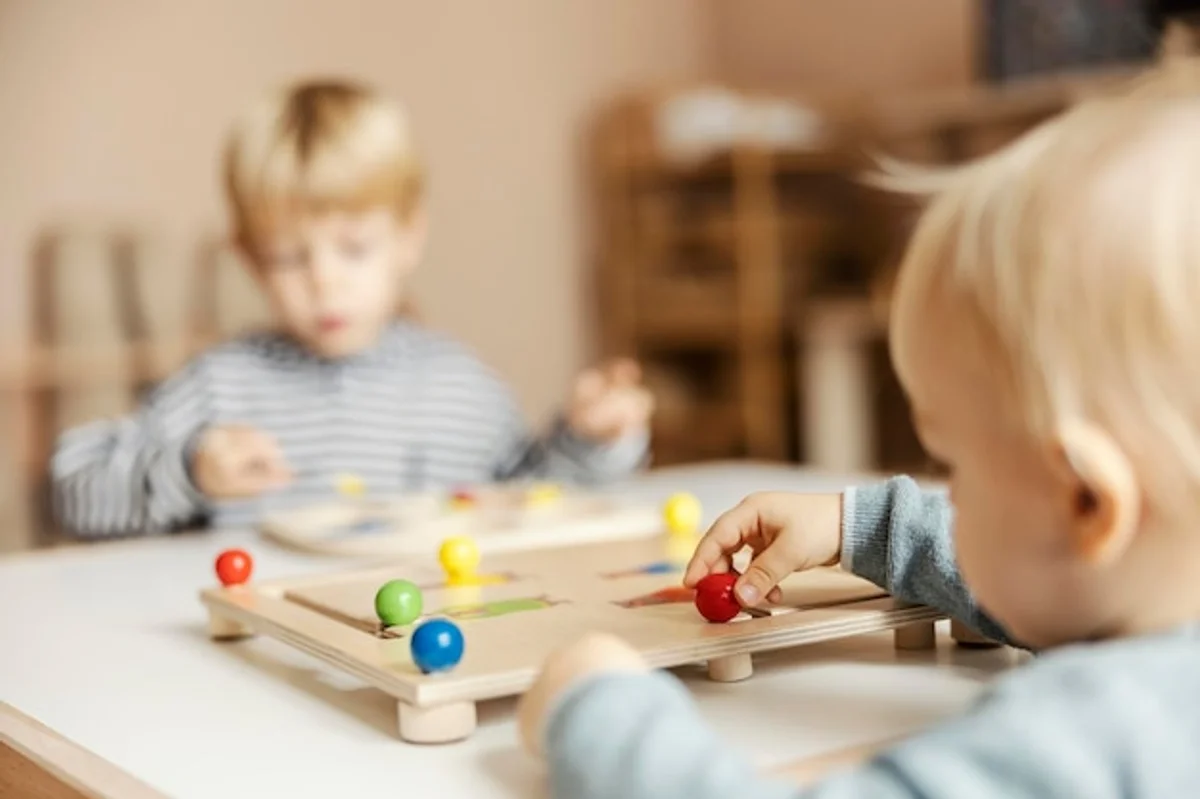 child playing with wooden toys and another child with interactive smart toys