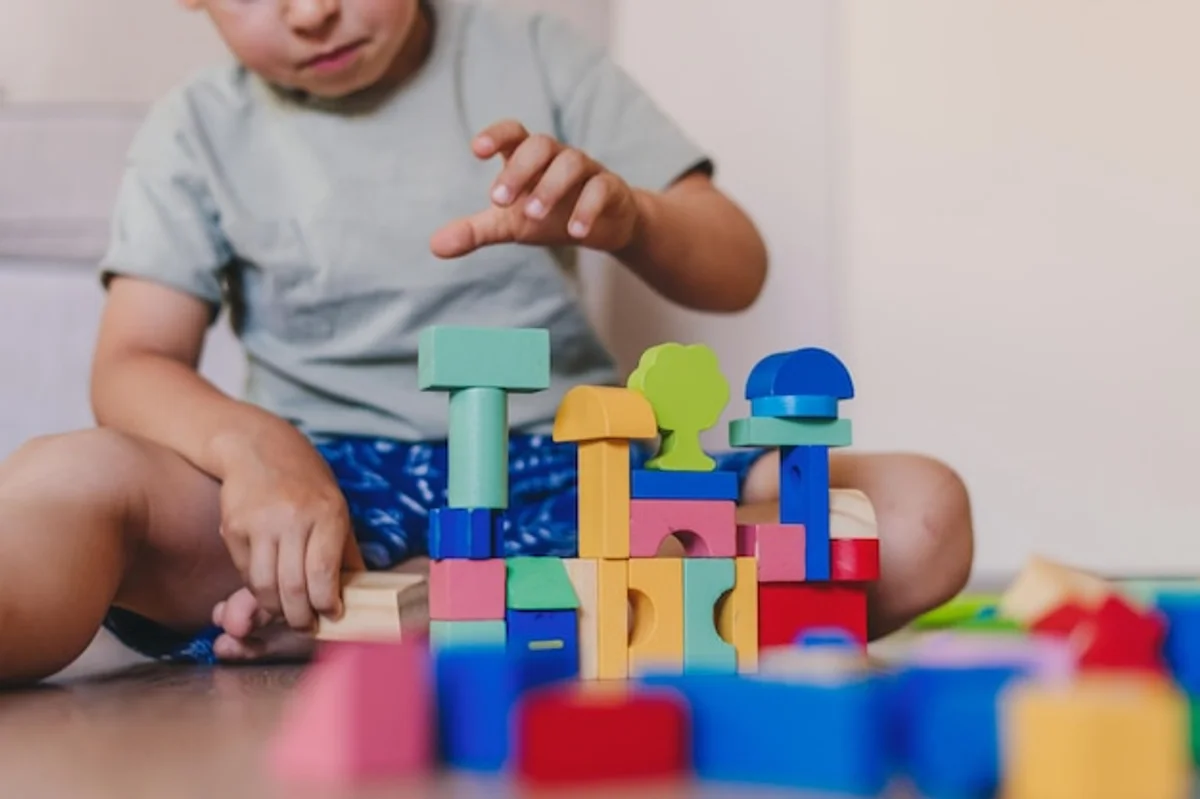 child playing with traditional wooden blocks