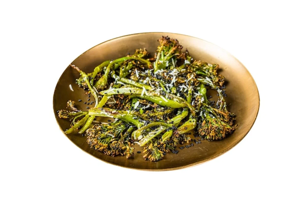 raw broccoli salad with lemon and parmesan on plate