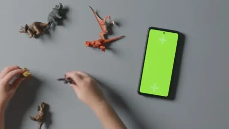 man reducing smartphone screen brightness