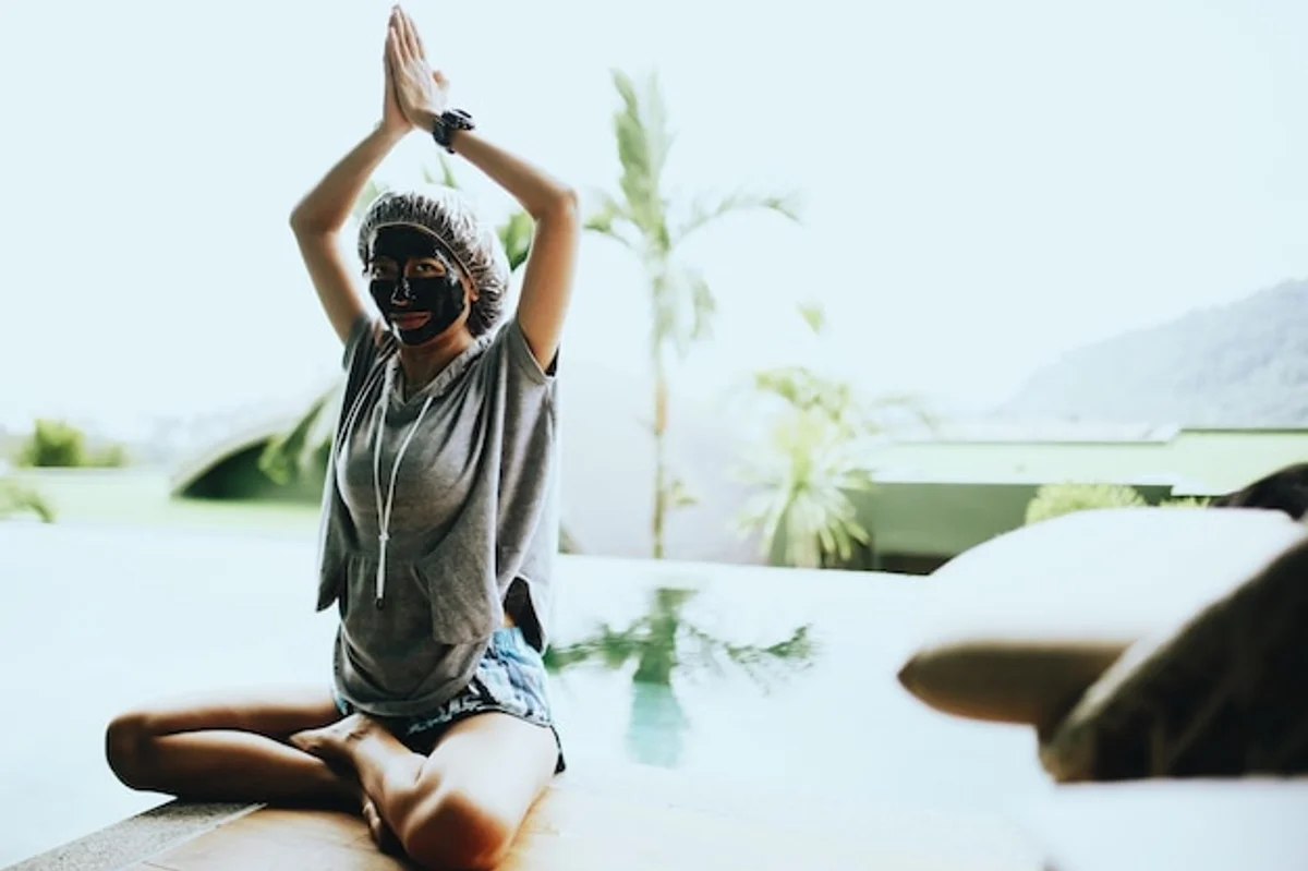 woman doing facial yoga relaxing morning window