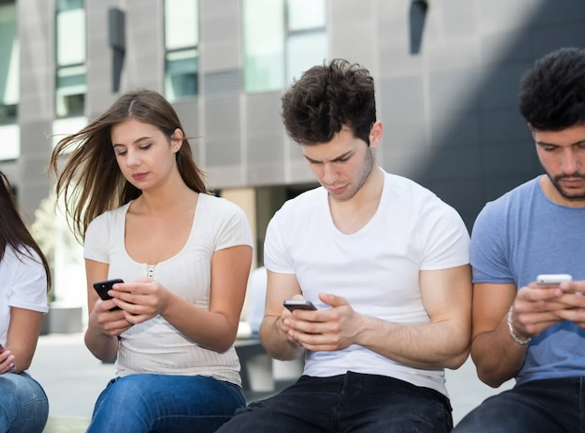 people using smartphones ignoring each other