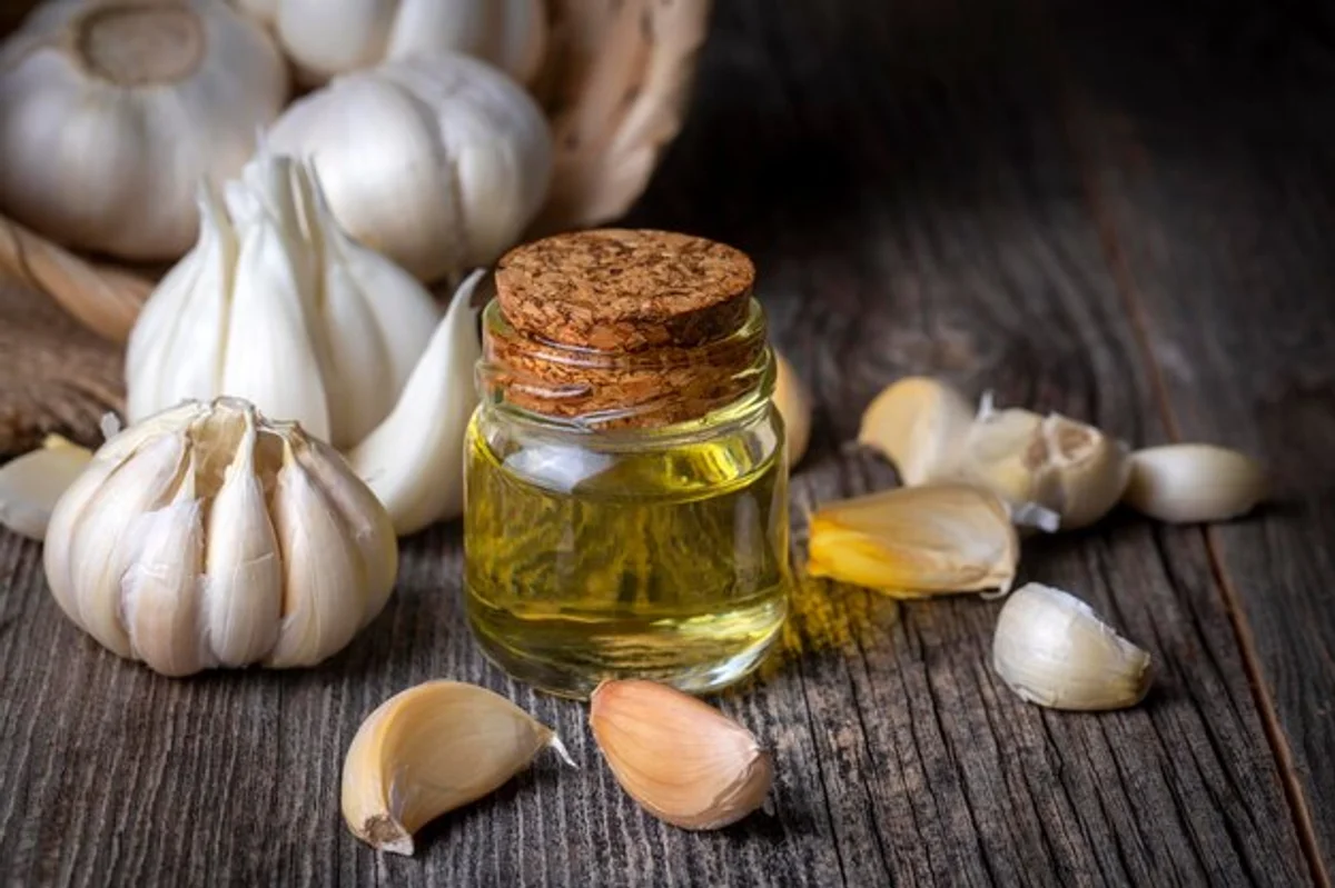 garlic cloves in olive oil glass jar preparation