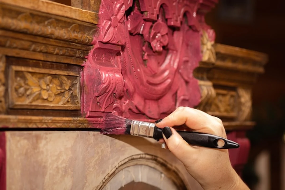 close up hand cleaning old paintbrushes arts and crafts restoration