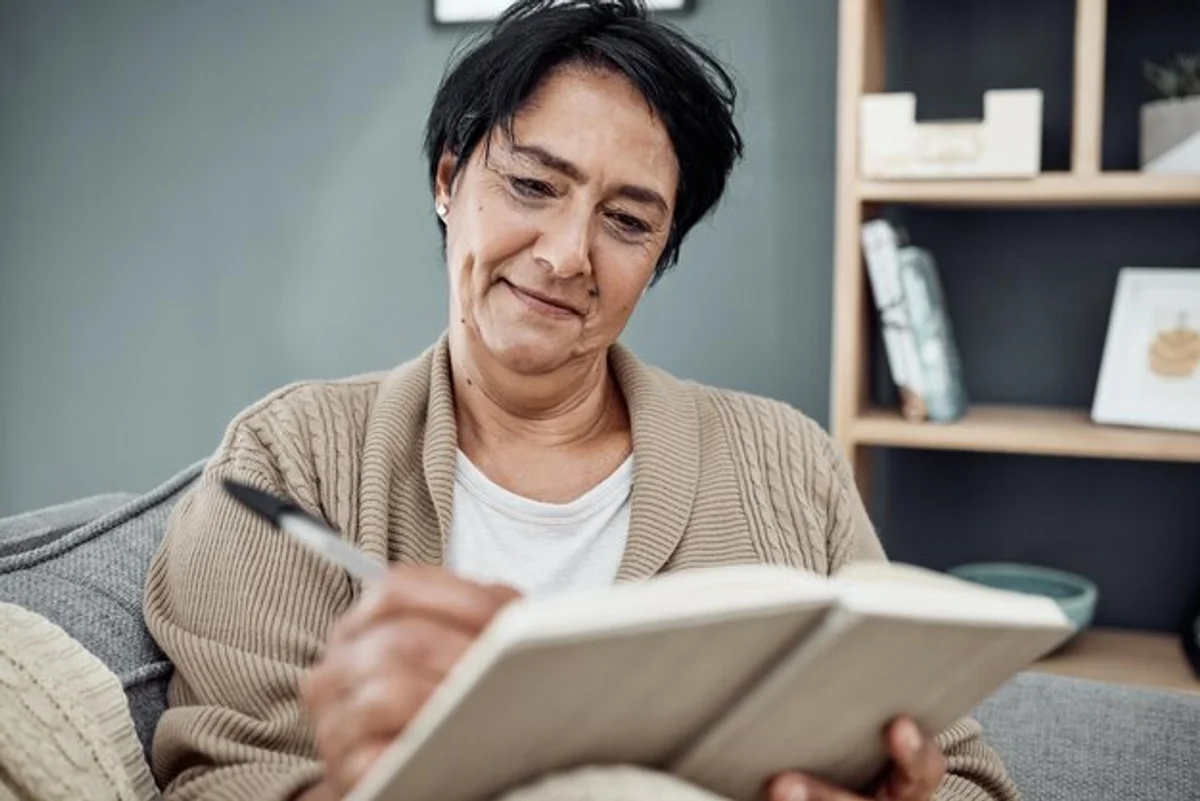 person reading old journals and taking notes