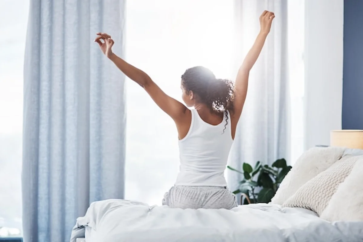 person stretching after long flight hotel room morning