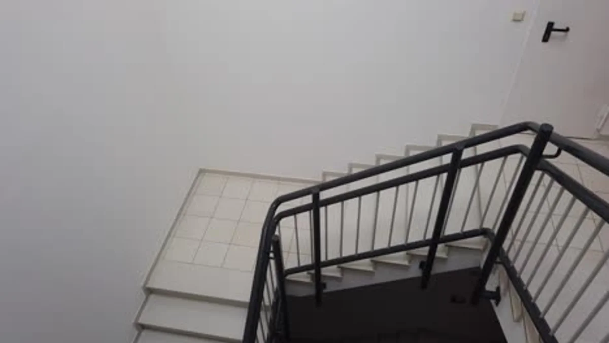 elderly woman secure stairs handrail daylight