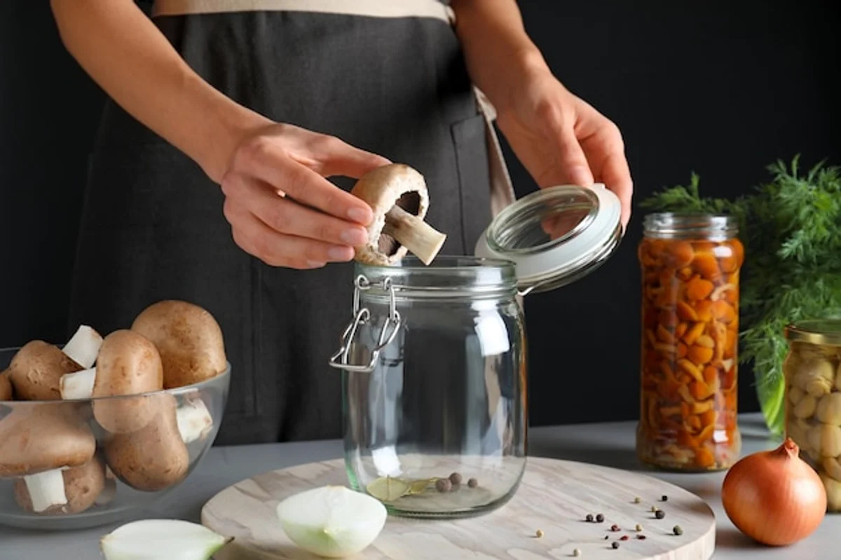 woman fermenting cabbage at home step by step kitchen close up