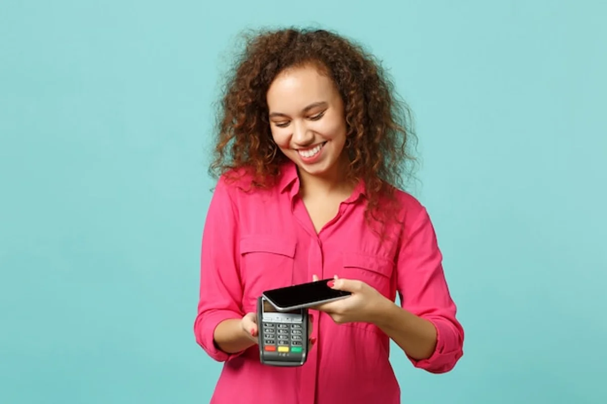 person checking savings on smartphone, smiling, modern lifestyle