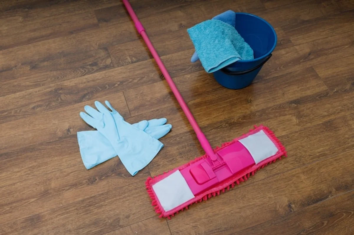 simple microfibre cloth cleaning floor, hands close up, bright modern apartment